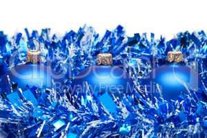 blue christmas balls with tinsel isolated over white background
