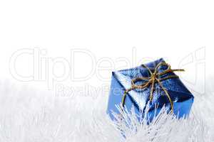 blue present box over the white tinsel background