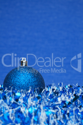 blue shiny christmas ball with tinsel