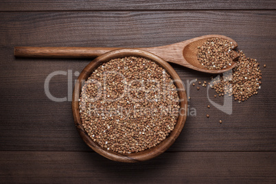 brown wooden bowl full of buckwheat on the table
