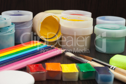 colorful pencils and paints on the table