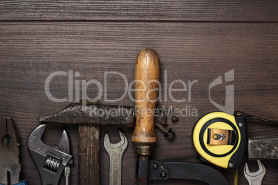 construction instruments on the brown wooden background