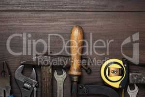 construction instruments on the brown wooden background