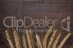 ears of rye on wooden background