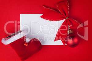 greeting card and christmas decoration on red background