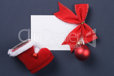 greeting card and christmas red decoration over grey background