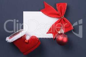 greeting card and christmas red decoration over grey background