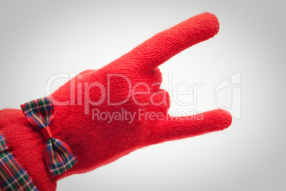 hand in red glove over grey background