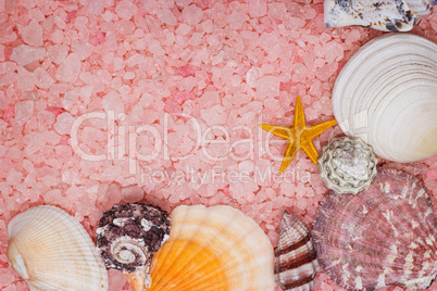 pink bath salt and seashells background