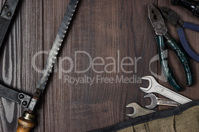 rusty construction instruments on the wooden background