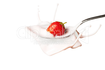 strawberry splashing into the spoon full of yoghurt