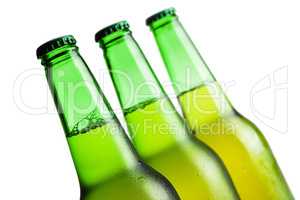 three green beer bottles isolated over white background