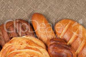variety of fresh bread over sackcloth background