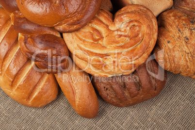 variety of fresh bread over sacking background