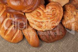 variety of fresh bread over sacking background