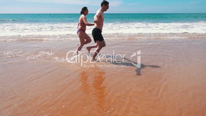Happy Couple Running on Beach, slow motion