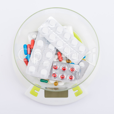 Pills in blister lying on an electronic balance