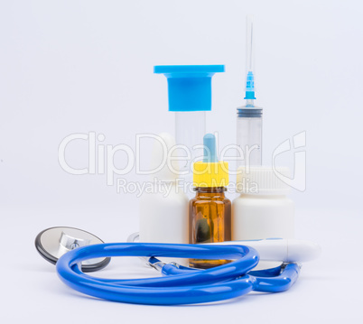 Stethoscope with bottles of medicine and syringe injection