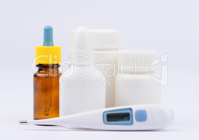 Thermometer, bottles with medical drugs and pills