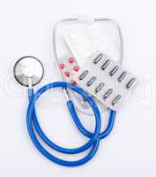 Stethoscope with pills and capsules in blister packs