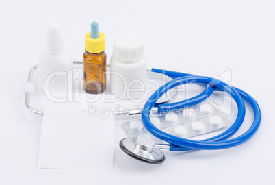 Stethoscope with medicine and a white sheet for recipes