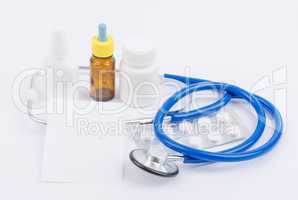 Stethoscope with medicine and a white sheet for recipes