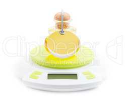 Bottle of olive oil stands on kitchen electronic scales