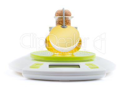 Bottle of olive oil stands on kitchen electronic scales