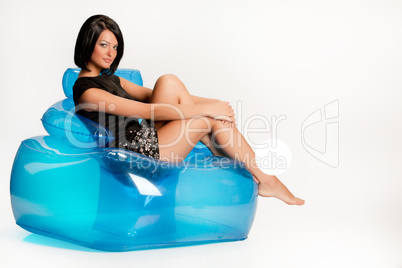 Young Woman On A Blue Inflatable Armchair
