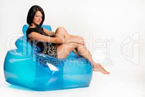 Young Woman On A Blue Inflatable Armchair