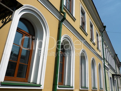 old yellow building with green storm-down pipe