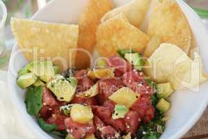 raw tuna salad meal with avocado