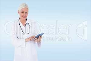 Composite image of smiling female doctor using table computer