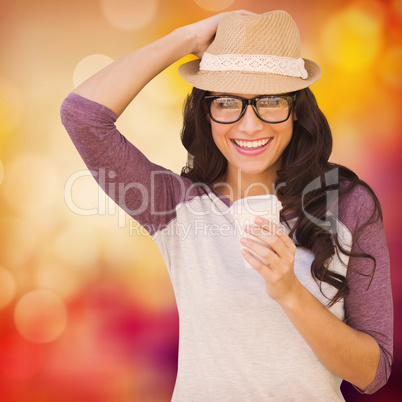 Composite image of brunette with disposable cup