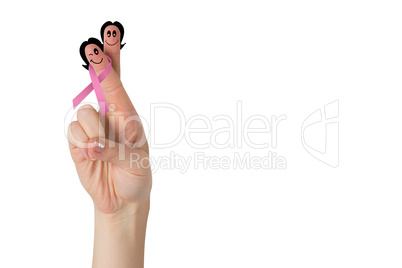 Crossed fingers with breast cancer ribbon