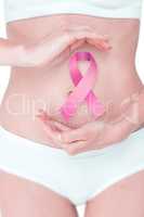 Composite image of woman with hands on belly