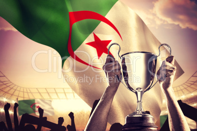 Composite image of successful rugby player holding trophy