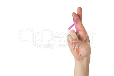Crossed fingers with breast cancer ribbon