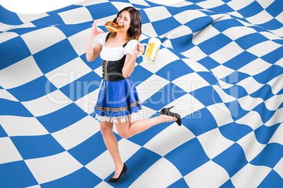 Composite image of pretty oktoberfest girl holding beer tankard