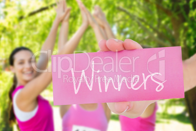 Winners against smiling women running for breast cancer awarenes