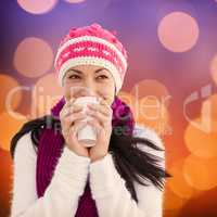 Composite image of winter brunette with coffee