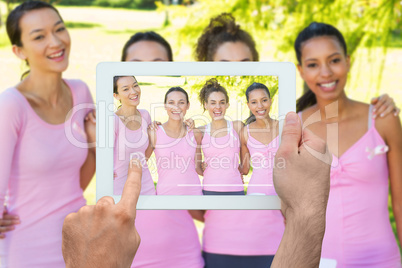 Composite image of hand holding tablet pc Composite image of hand holding tablet pc