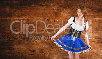 Composite image of oktoberfest girl spreading her skirt