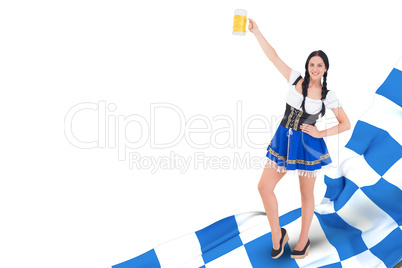 Composite image of pretty oktoberfest girl holding beer tankard