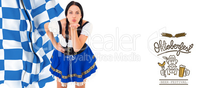 Composite image of pretty oktoberfest girl blowing a kiss