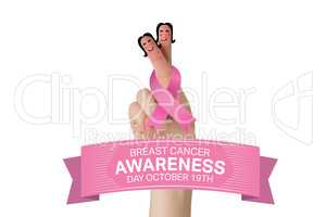 Composite image of crossed fingers with breast cancer ribbon