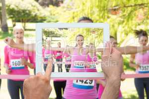 Composite image of hand holding tablet pc