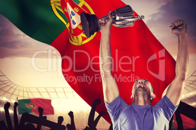 Composite image of happy rugby player holding trophy