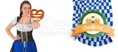 Composite image of pretty oktoberfest girl holding pretzel