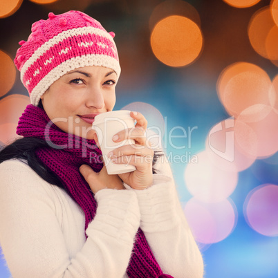 Composite image of woman holding coffee cup